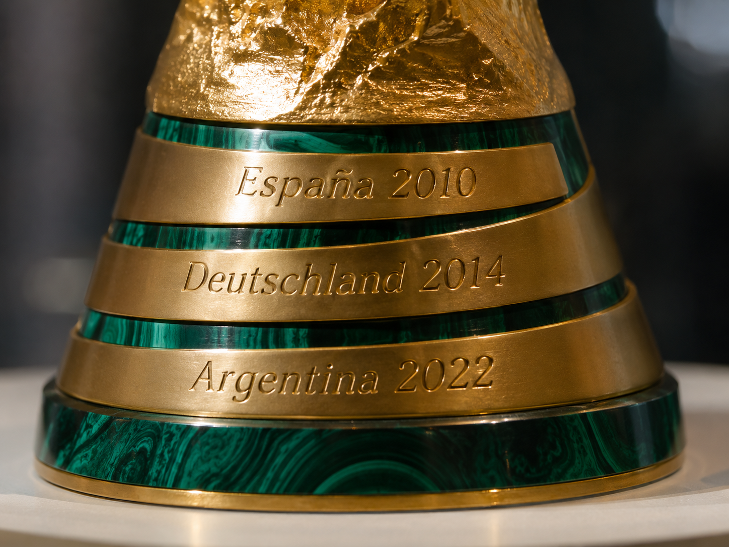 Close-up of World Cup trophy base showing engraved winner names.